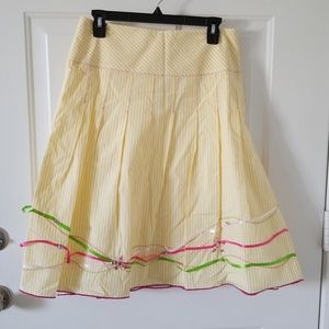 Yellow and white striped skirt with detail on bot